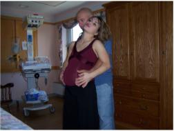 Leaning on her partner while standing during early labor