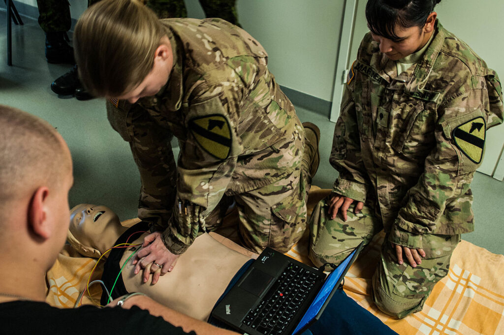 Army Maj. Catherine Sampert, a pediatric gastroenterologist, takes over performing chest compressions as Spc. Pamela Martinez, a combat medic, attached to 2nd Battalion, 8th Cavalry Regiment, 1st Brigade, 1st Cavalry Division, takes a break from having done chest compressions