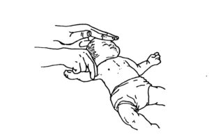 Figure 6-3. Checking an infant for a brachial pulse.
