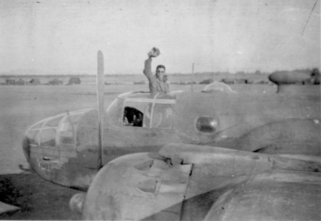 B-25C, known as "443", belonging to the 417th NFS. Tom flew this aircraft as a copilot for 4 hours on April 2, 1945. The B-25's nose art read "Pizzonia". The pilot standing up is Paul Peyron of the 417th NFS when in Corsica.