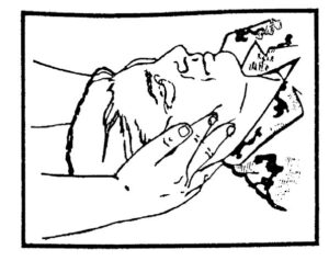 Figure 2-4. Applying manual traction to a casualty's head (casualty on his back).