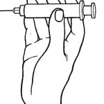 Figure 2-5. Hold barrel of syringe between thumb and index finger.