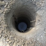 Concrete "cookie" in the bottom of the post hole.