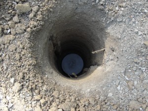 Concrete "cookie" in the bottom of the post hole.